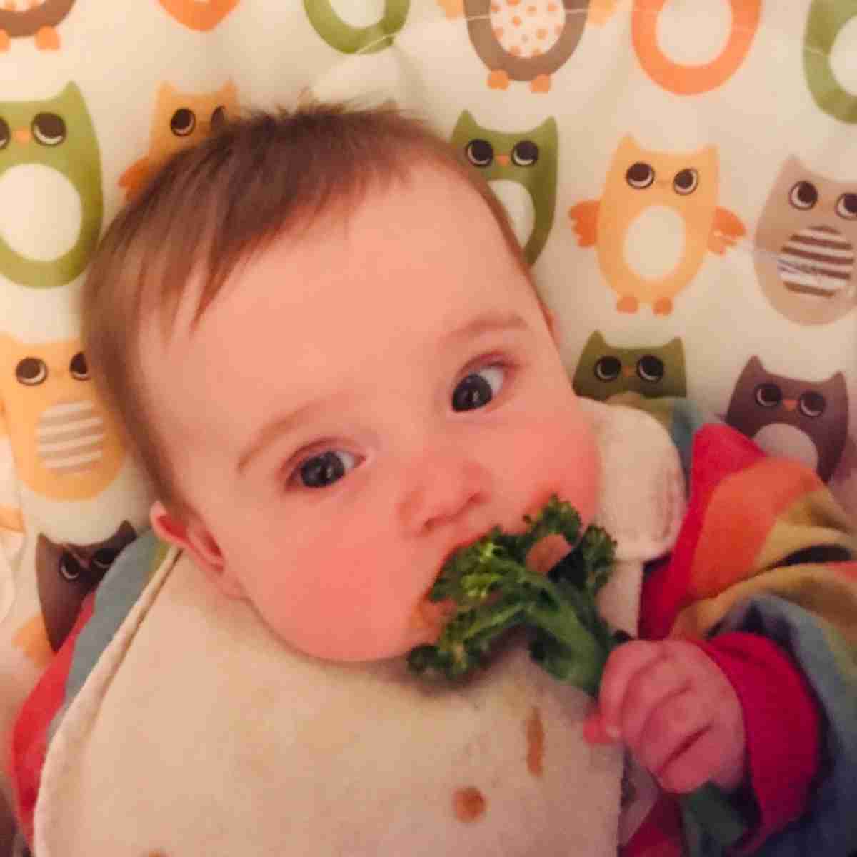 baby eating broccoli