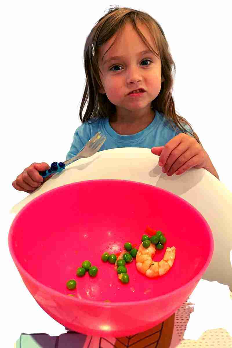 Child with a small portion of food in bowl 