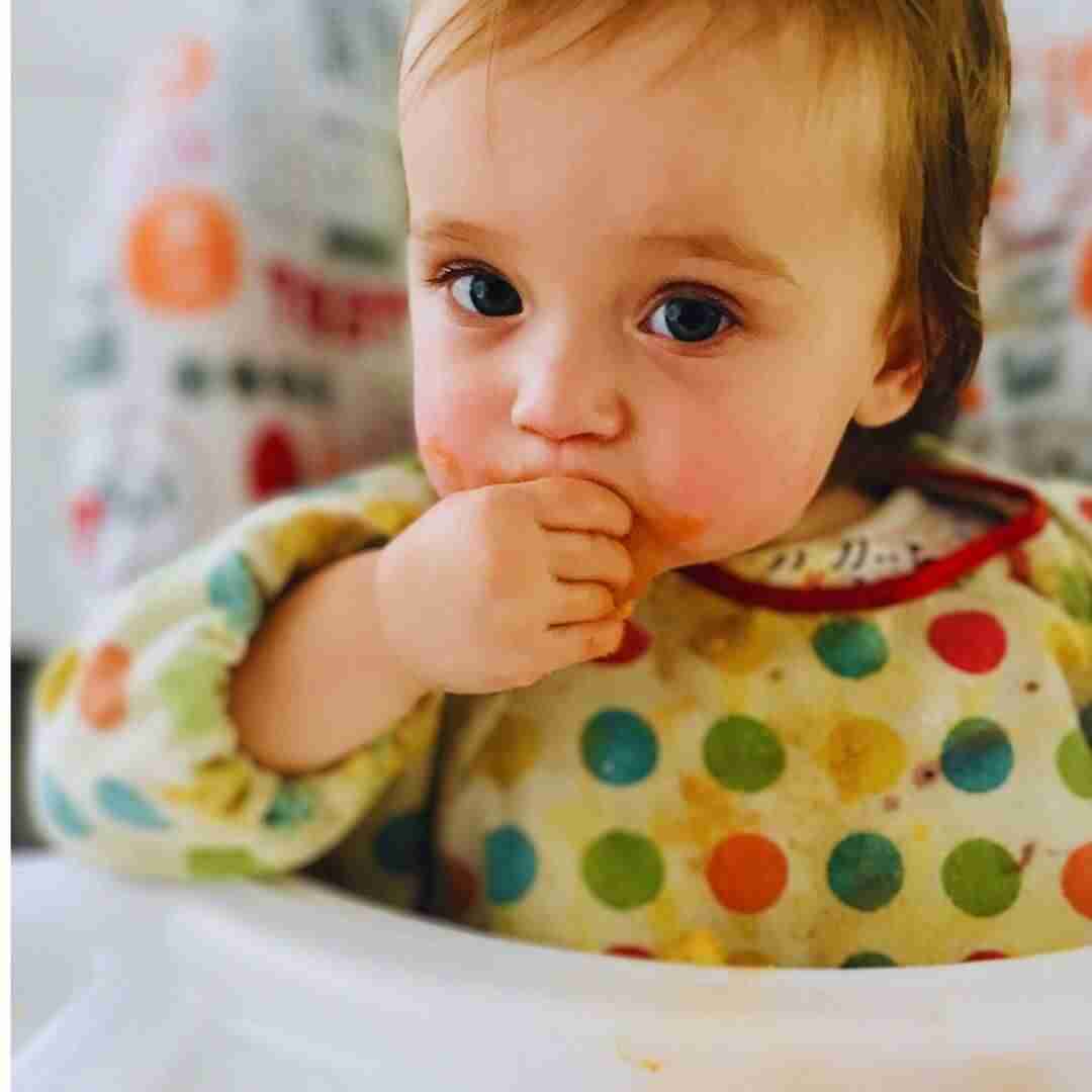 Baby eating in a highchair