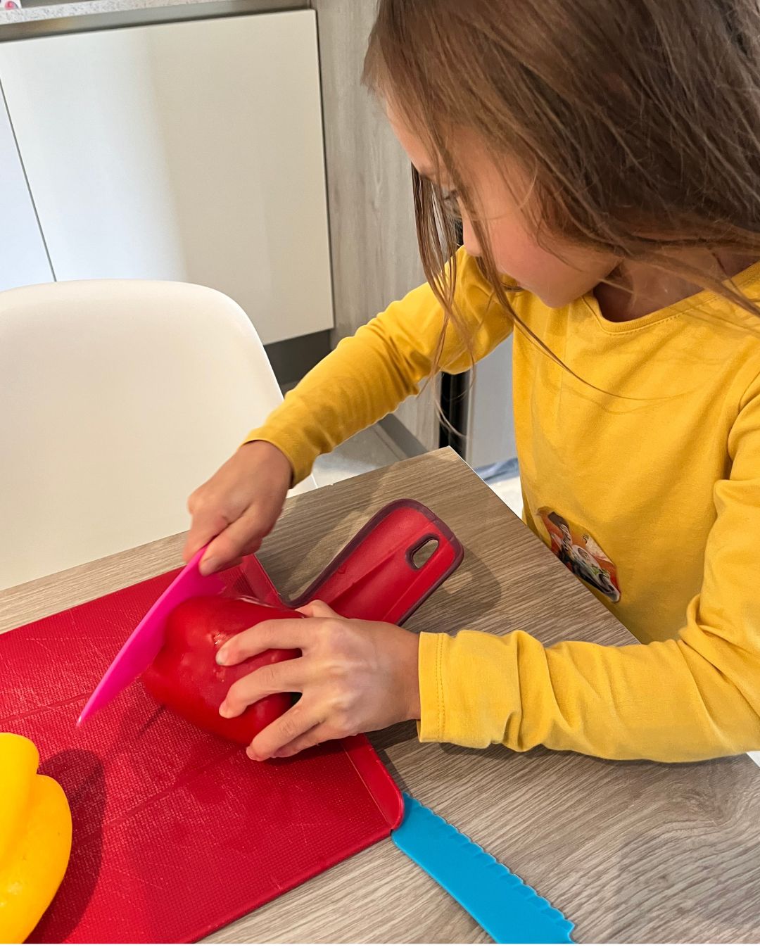 girl chopping a pepper